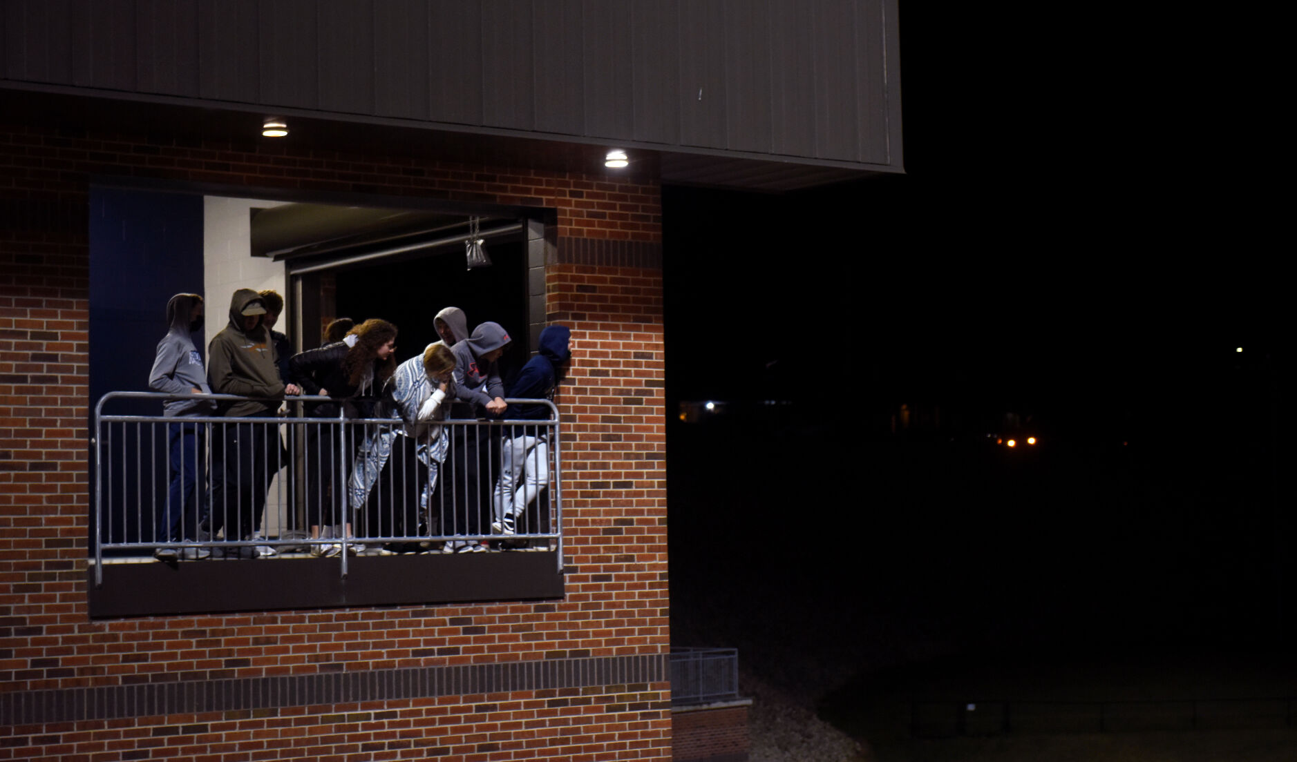 A group of fans overlook the field